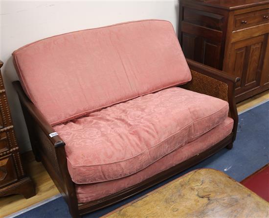 An oak three piece bergere suite, with single caning, settee W.140cm